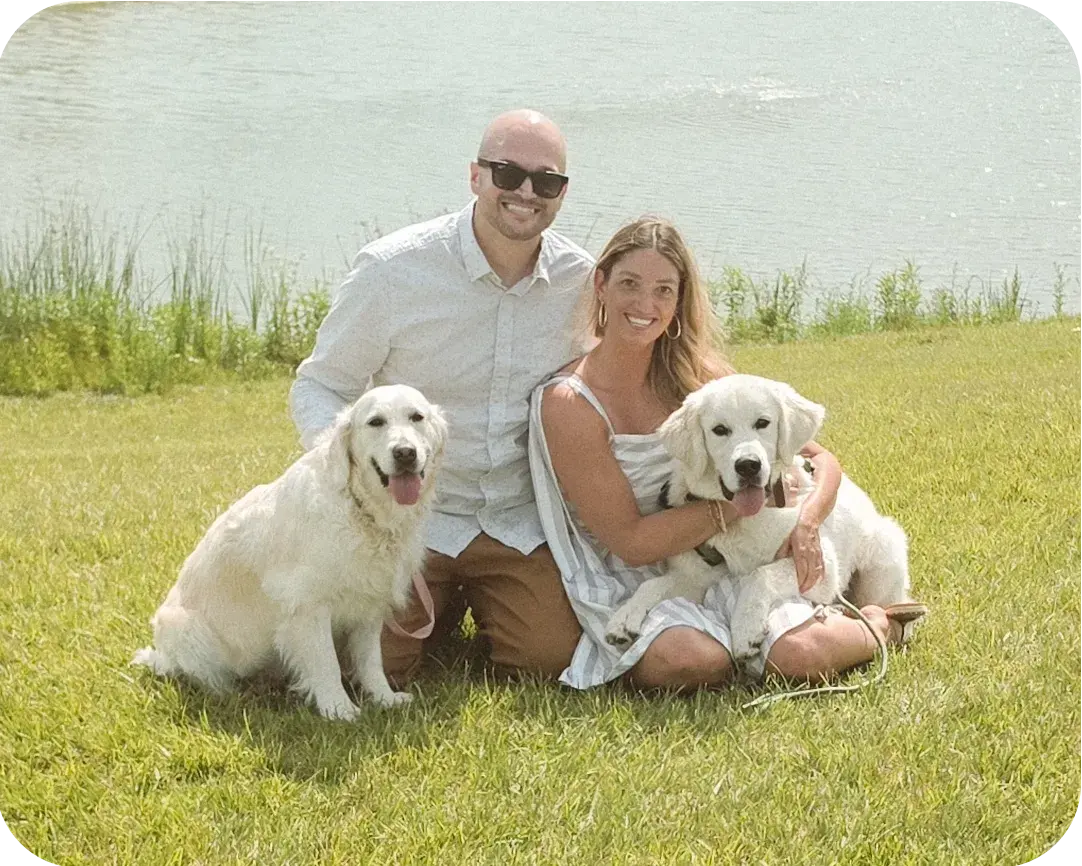 The Ivory & Pine family with their English Cream Golden Retrievers in a sunlit field